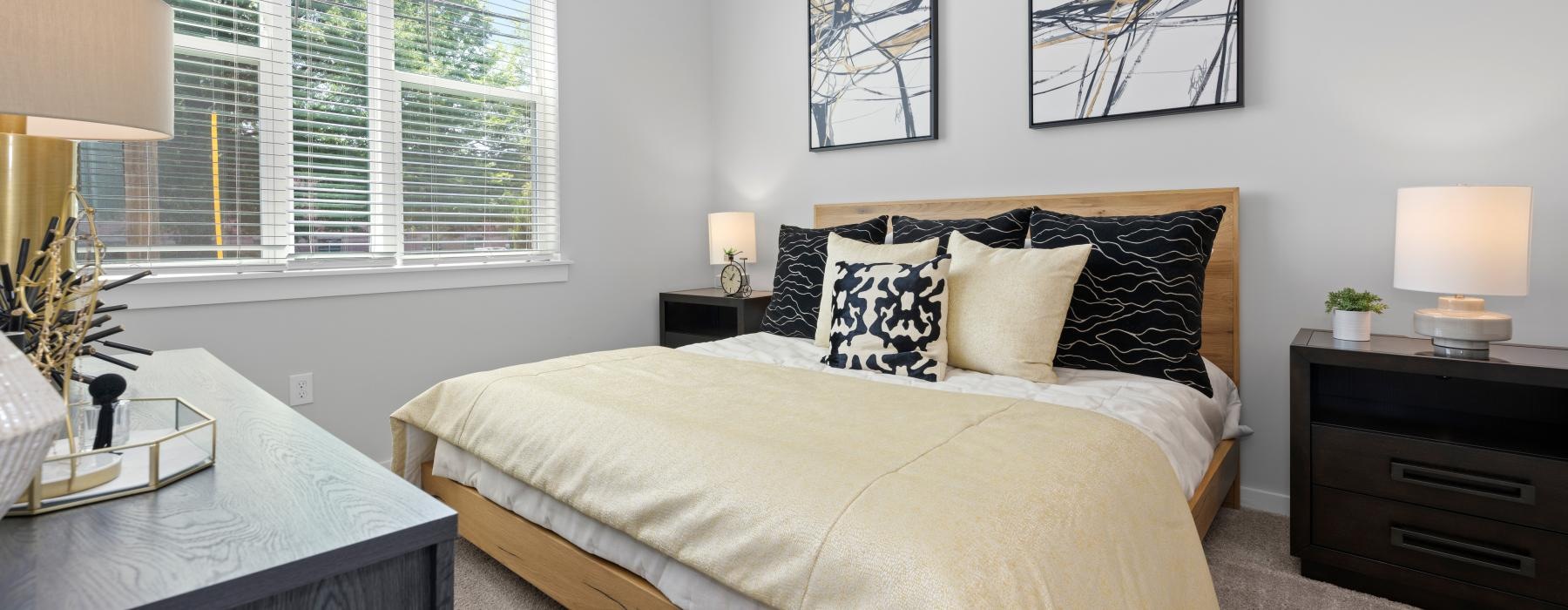 a bedroom with a bed and lamps